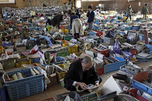 The Herald-Dispatch Japanese search for family albums and belongings among a pile of items recovered from the area devastated by the March 11 earthquake and tsunami and displayed at a school gymnasium in Natori, Miyagi Prefecture, Japan, Wednesday, A