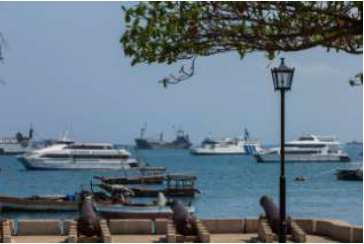 Zanzibar shipping traffic today â dhows in the foreground.