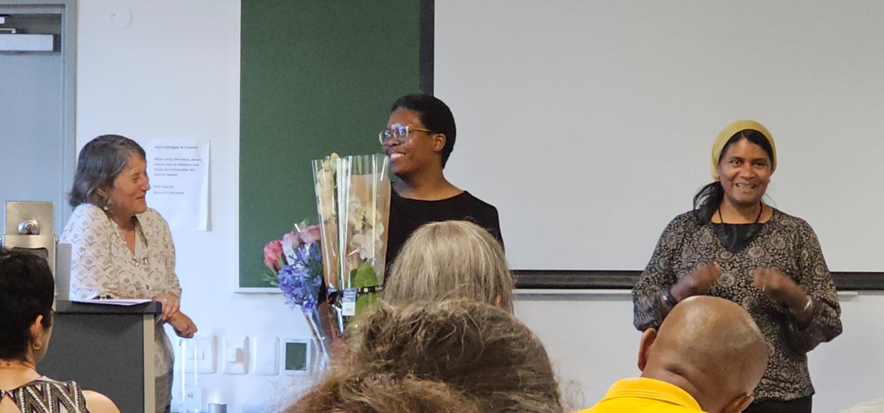 Xoli gives Cathy flowers