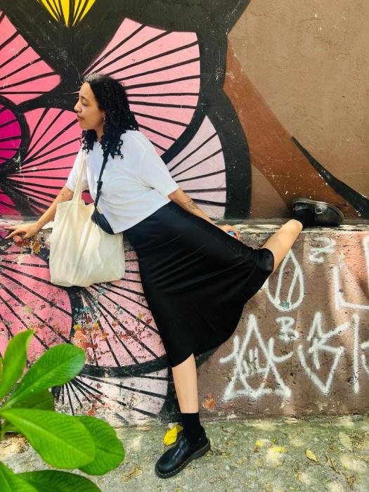 Posing next to mural