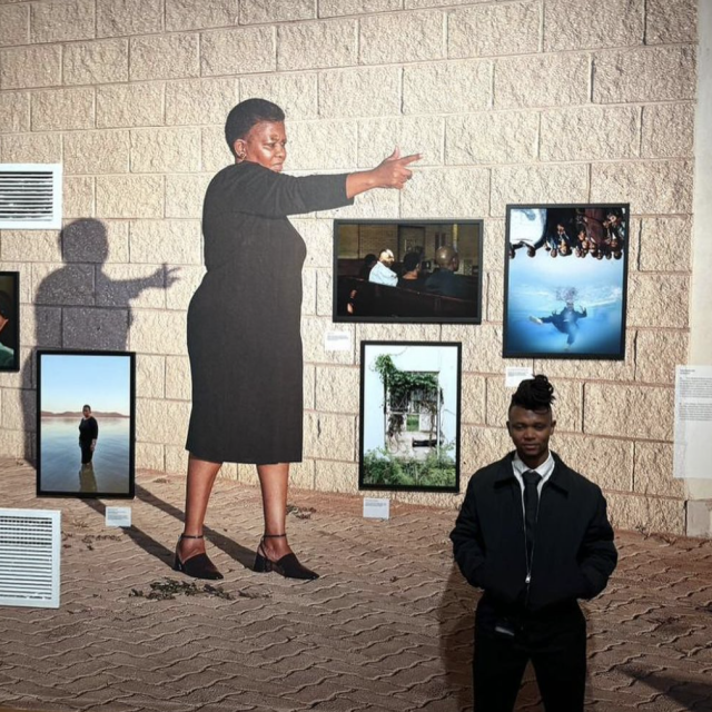 Thero in front of artwork