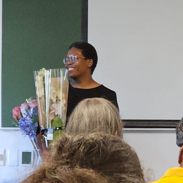 Xoli gives Cathy flowers